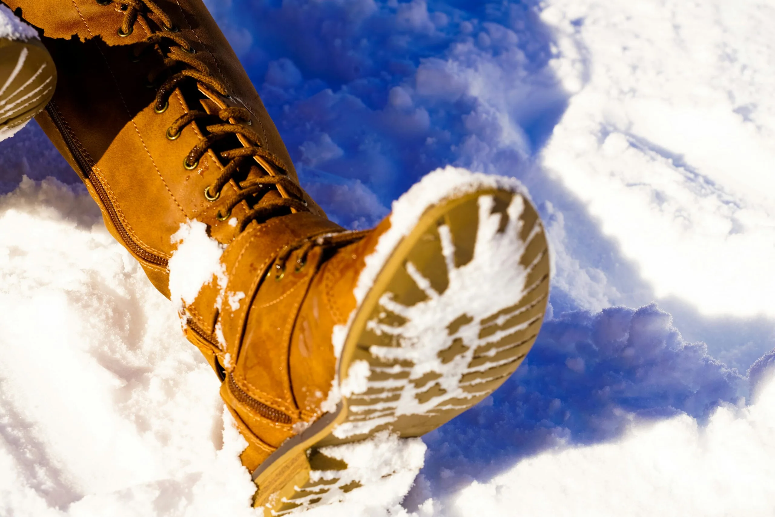 Alt text: Winter boots resting in fresh snow. Image by Nikita Khandelwal from Pexels