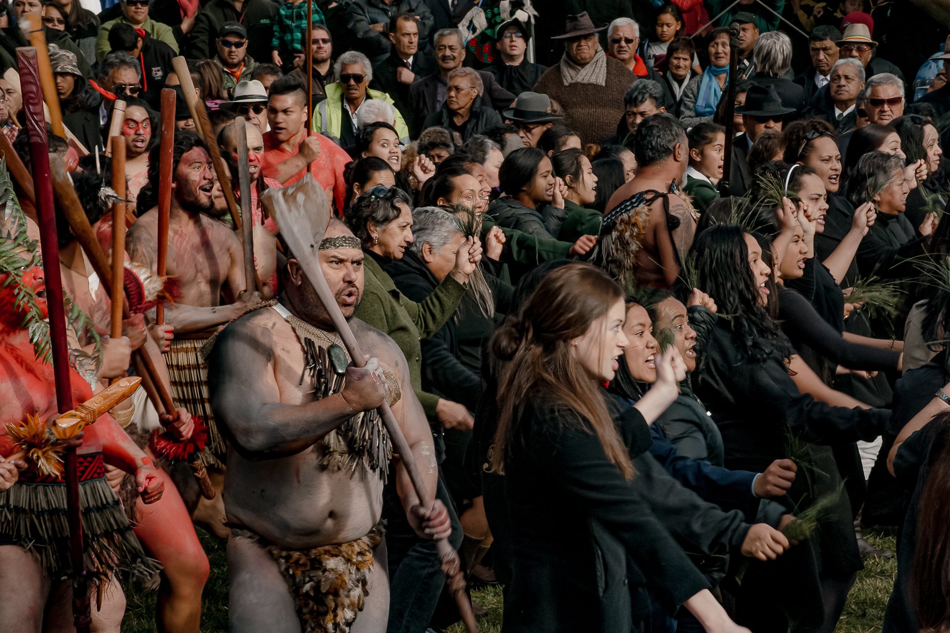 Tūhoe people perform a haka, a traditional dance and welcome (also sometimes a chant of challenge) in Tāneatua, New Zealand, as government officials arrive for the 2014 Tūhoe-Crown Settlement Day ceremony,where the government formally apologized for historical injustices.