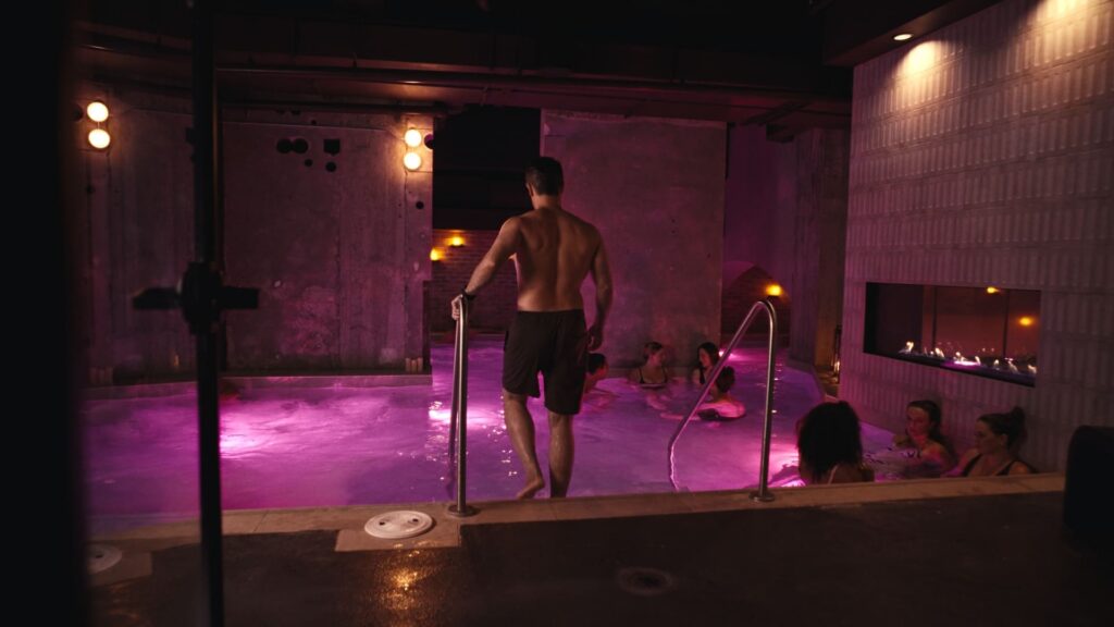 People socializing in the illuminated pool, finish the visual story with people, not an empty space. Best Kept MTL