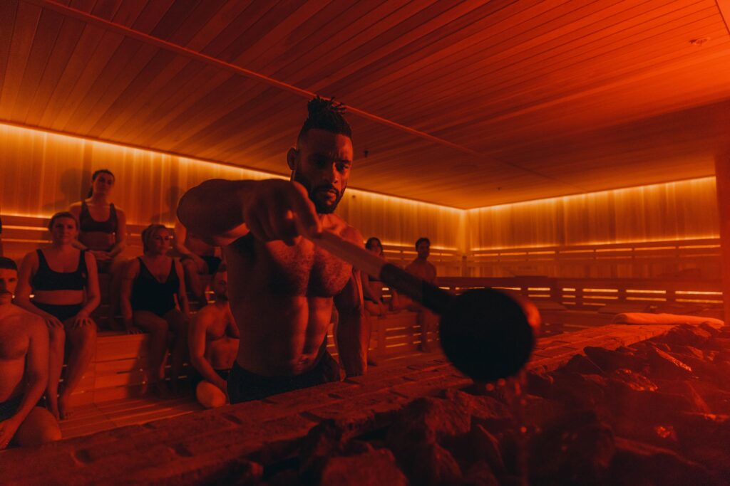 Sauna master pouring water over the stones. Best Kept MTL