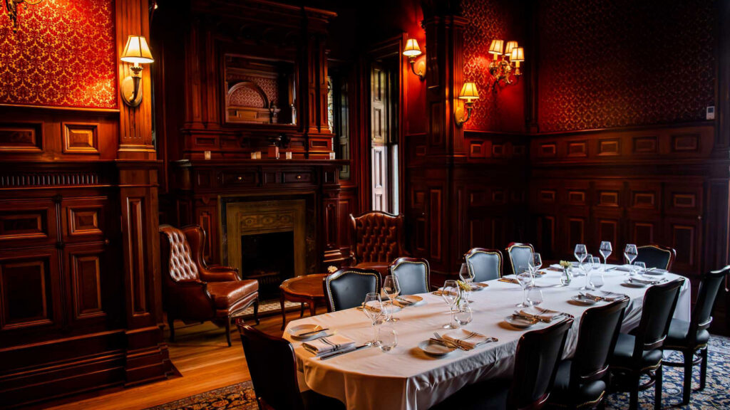 Bar George private dining room with carved wood and a fireplace