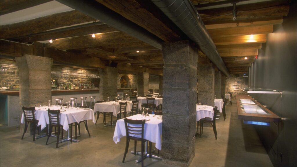 Da Emma dining room with stone pillars and exposed timber beams