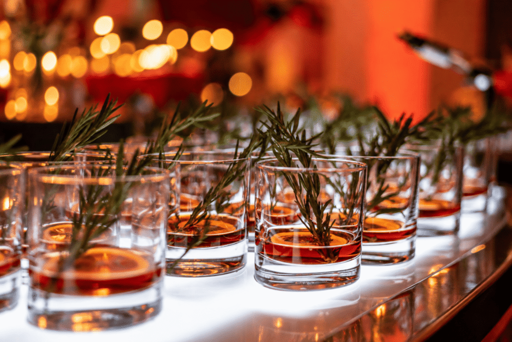 Beautifully arranged rosemary-garnished cocktails.