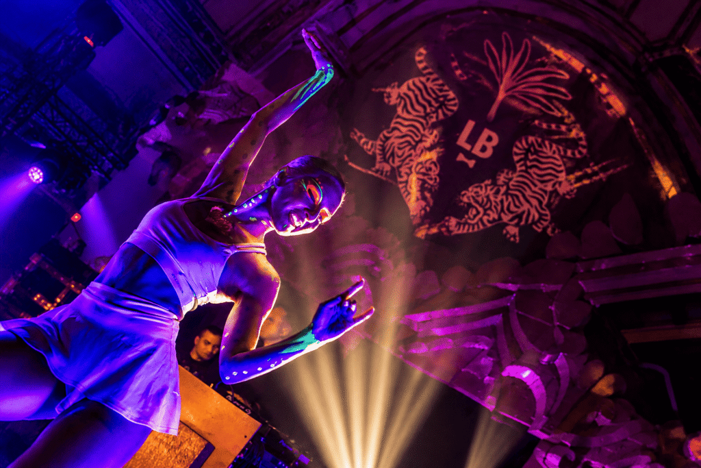 Neon-lit performer at a previous Let's Bond edition