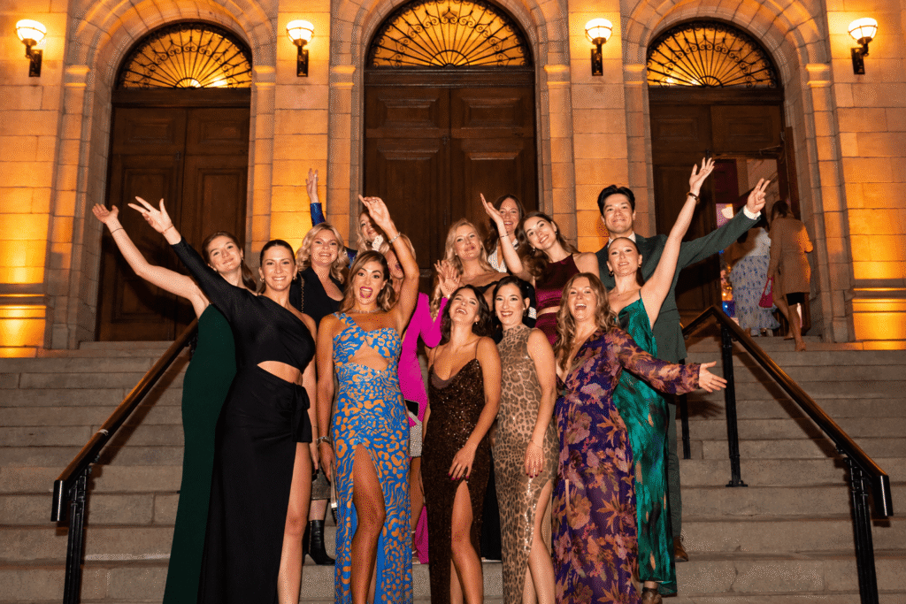 Group of guests celebrating together on the venue steps.