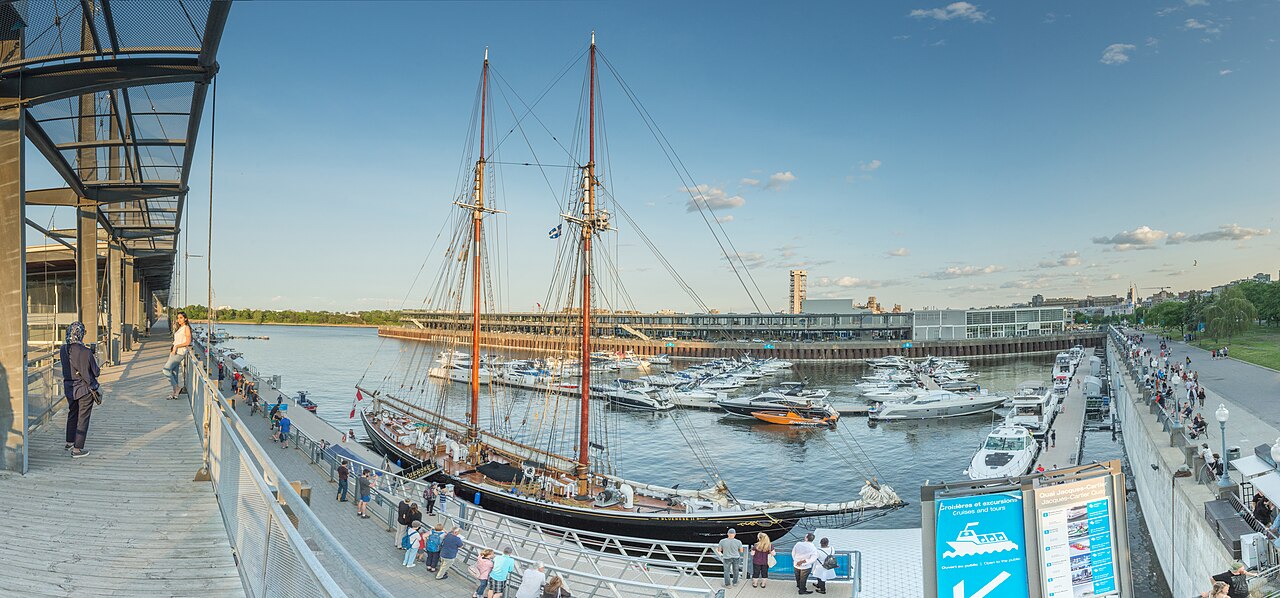 Sailing ship, marina and waterfront promenade in Montreal’s Old Port