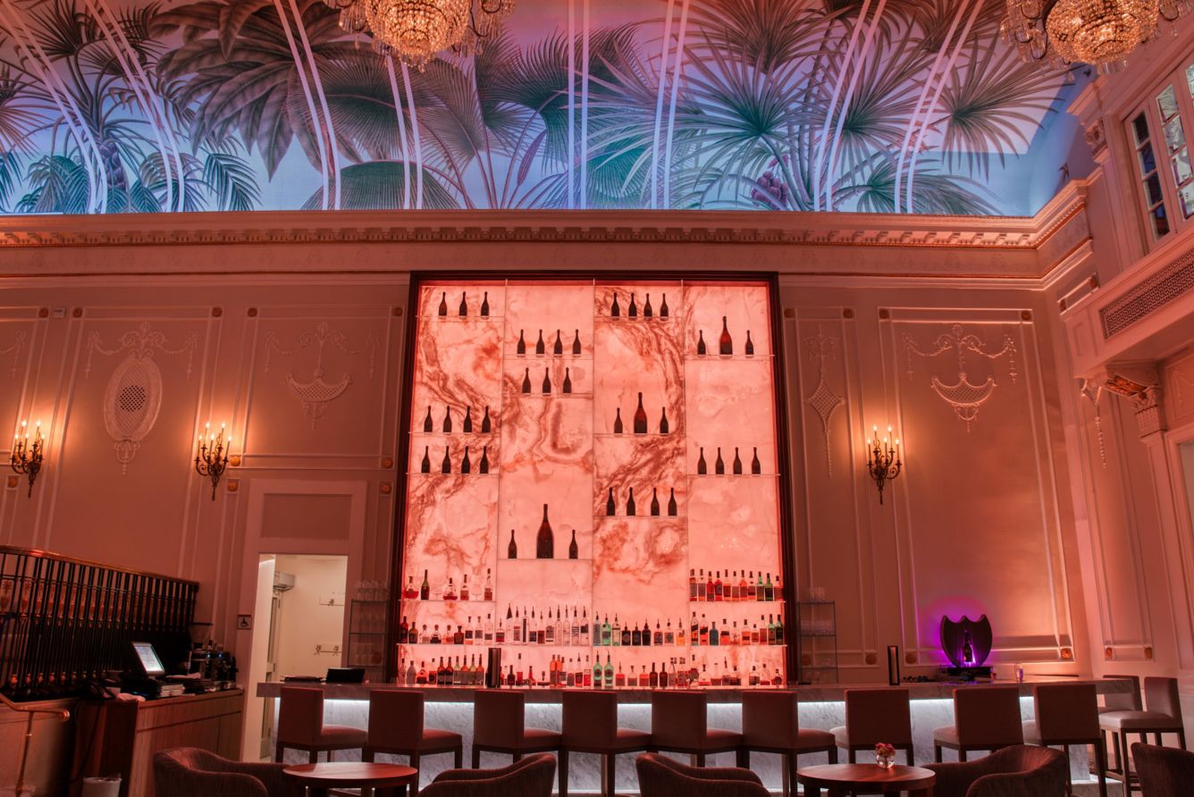 Palm mural and glowing pink bar at Palm Court Montreal